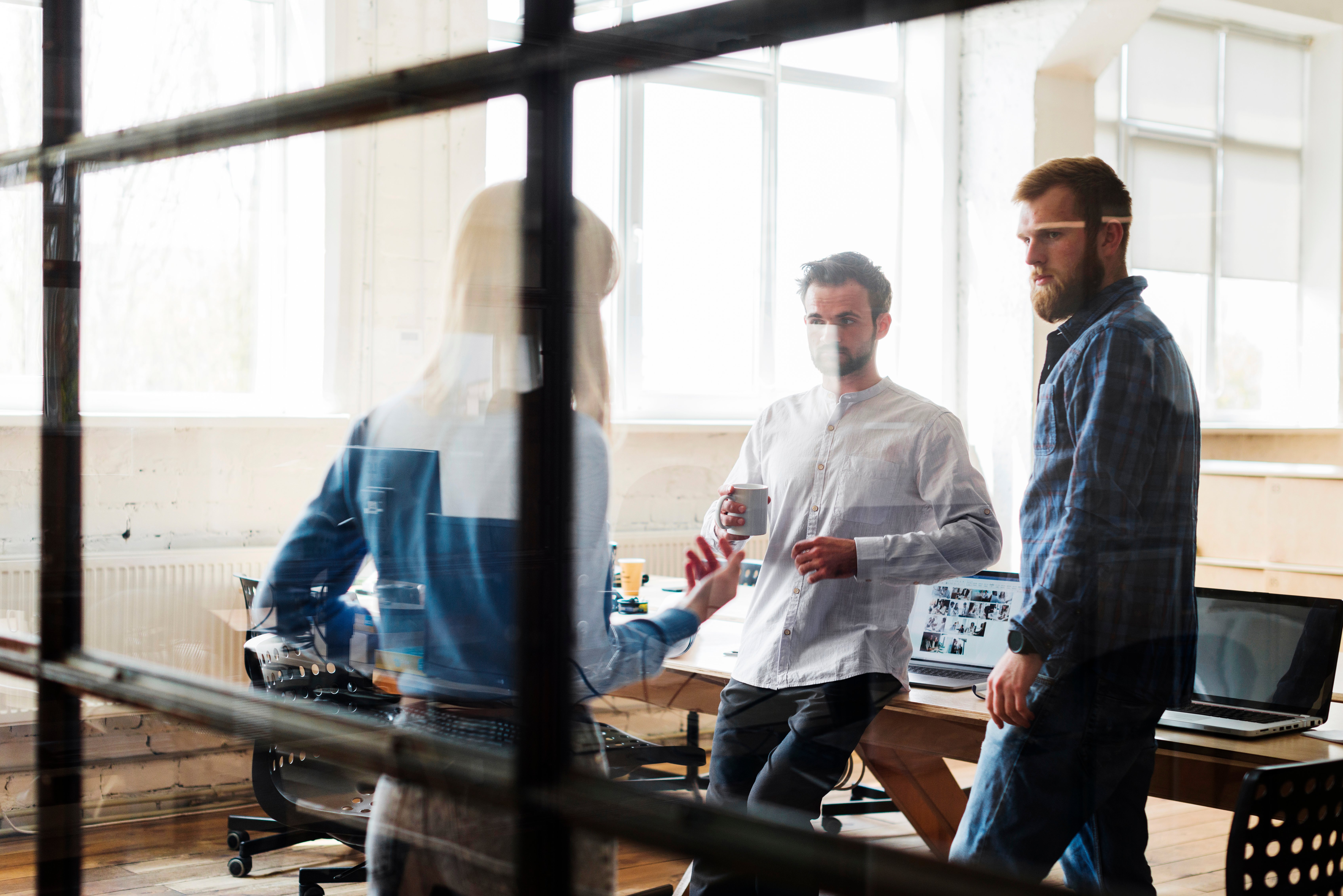 colleagues-discussing-with-each-other-office